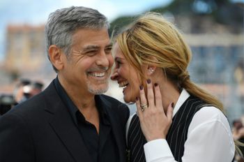 US actors George Clooney (L) and Julia Roberts promote the film "Money Monster" at the 69th Cannes Film Festival