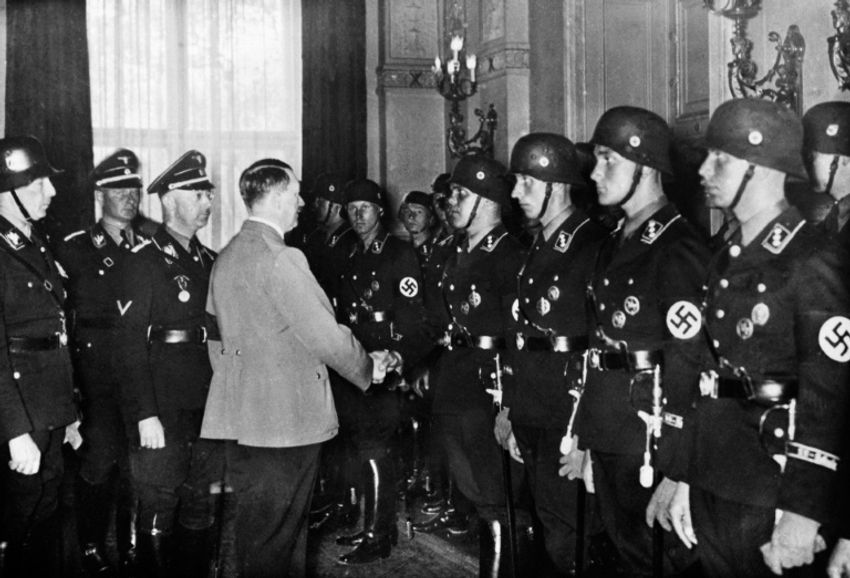 Adolf Hitler shakes hands with young members of an elite Nazi SS unit 1937 in Berlin