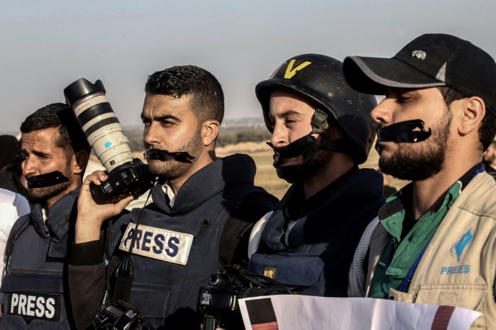 AFP / SAID KHATIB Palestinian journalists near the Israel-Gaza border on April 8, 2018.