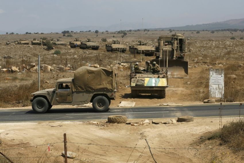 Israeli armoured vehicles stage a military exercise in the annexed Golan Heights near the armistice line with Syria on August 7, 2018