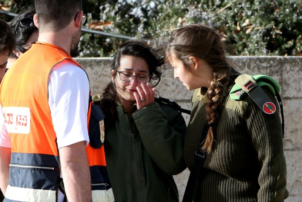 Israeli medical personnel assist an Israeli soldier who was an eye witness to the attack in Jerusalem, on January 8, 2017