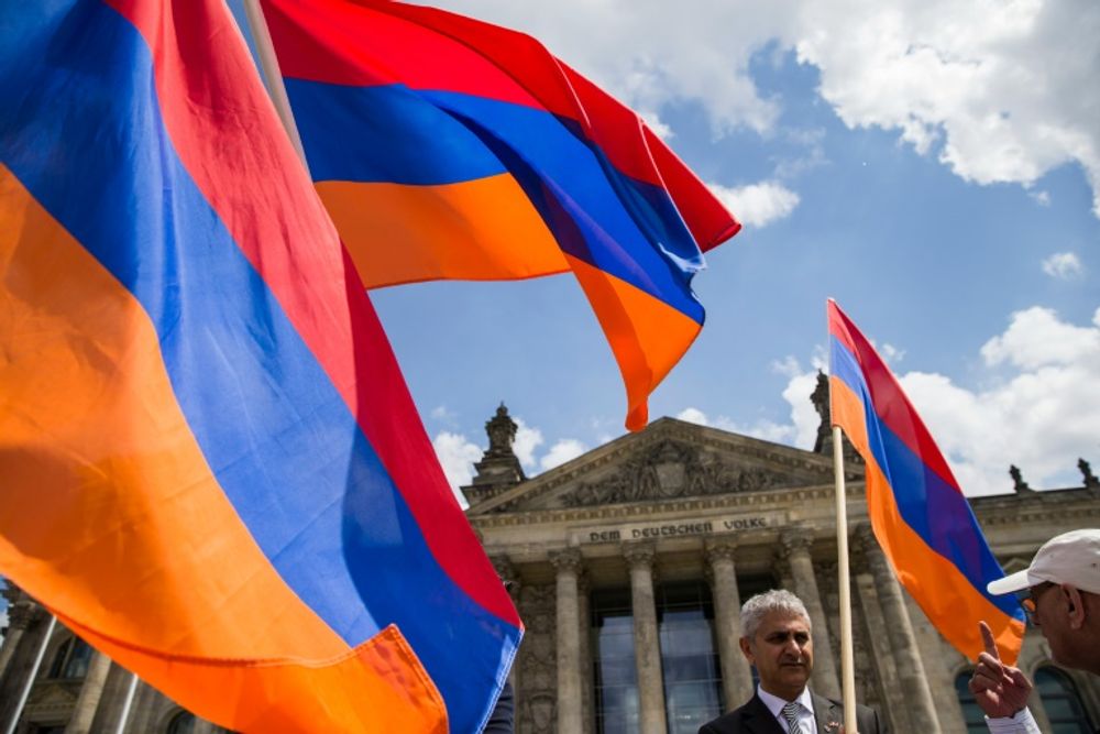 Armenian activists wave flags outside the Bundestag in Berlin after lawmakers voted to recognise the Armenian genocide, on June 2, 2016