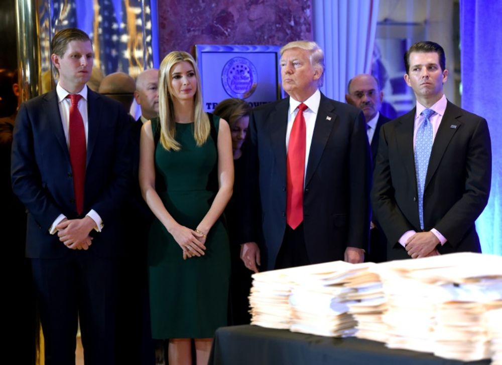 US President Donald Trump along with his children Eric(L) Ivanka and Donald Jr. in 2017: they were accused in a New York lawsuit Thursday of misusing funds at the Donald J. Trump foundation, the president's personal charity