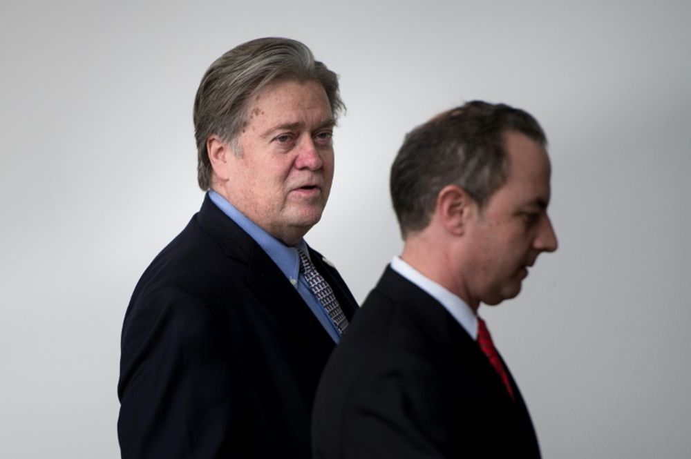 Trump advisor Steve Bannon (L) and White House Chief of Staff Reince Priebus walk through the colonnade of the White House January 27, 2017 in Washington, DC