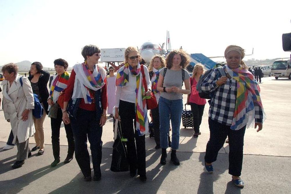 A delegation taking part in international women's march to promote peace and reconciliation, arrives at Pyongyang airport, on May 19, 2015
