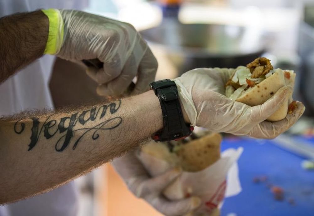 A cook prepares a shawarma with seitan (wheat meat), during the 'Vegan Fest' fair in the Israeli city of Ramat Gan, near Tel Aviv, on October 13, 2014