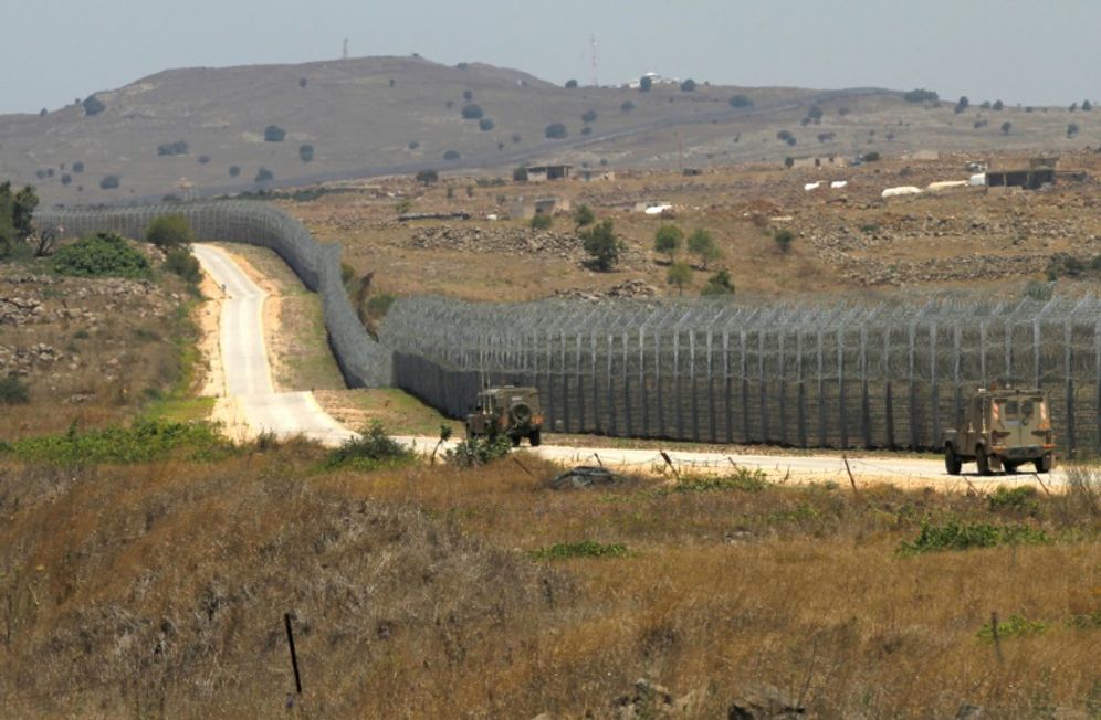 JALAA MAREY (AFP/File) Israeli army vehicles patrol the border fence with Syria in the Golan Heights on July 4, 2018