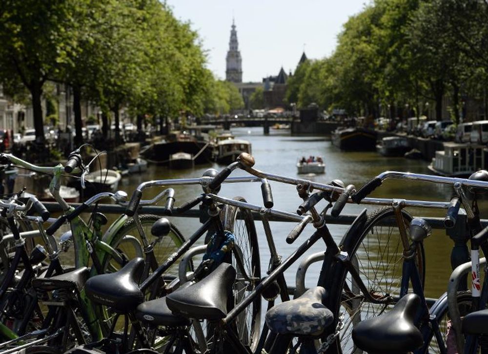 Bikes are seen near a canal in Amsterdam where cycling is a popular and environmentally friendly way to get around