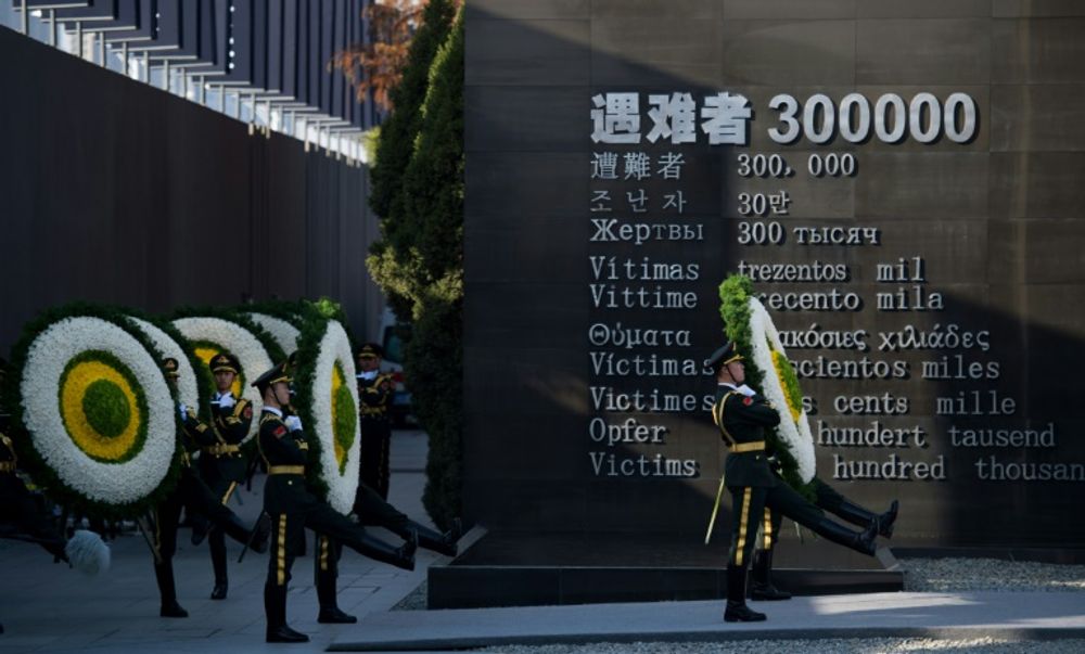 Soldiers of the People's Liberation Army attend a memorial ceremony at the Memorial Hall of the Victims in Nanjing Massacre, in Nanjing city on  December 13, 2014