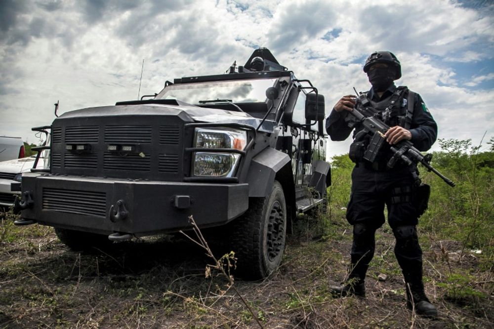 Mexican police participate in an operation to bust a clandestine lab for making synthetic drugs in Carrizalejo, in the state of Sinaloa, in July 2018