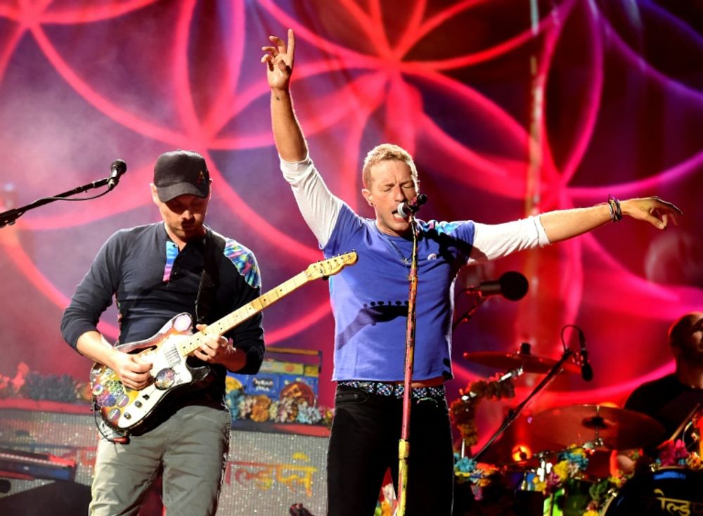 Jonny Buckland (L) and Chris Martin of Coldplay perform at the Rose Bowl in Pasadena, California, on August 20, 2016
