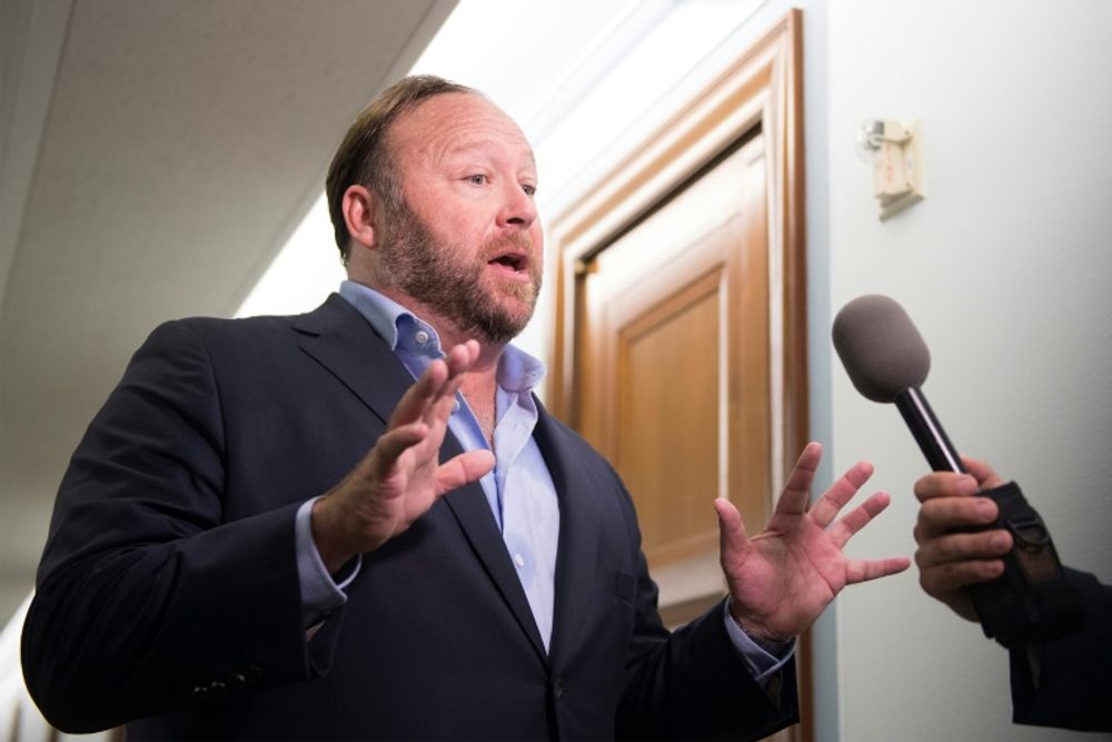 Far-right media personality Alex Jones speaks to reporters on September 5, 2018, in Washington, DC, the United States.