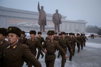 Korean People's Army soldiers leave after bowing before the statues of late North Korean leaders Kim Il Sung and Kim Jong Il during National Memorial Day in Pyongyang