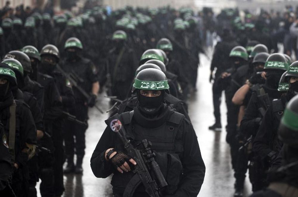 Palestinian militants of the Ezzedine al-Qassam Brigades, Hamas' armed wing, take part in a parade marking the Islamist movement's 27th anniversary, on December 14, 2014 in Gaza City