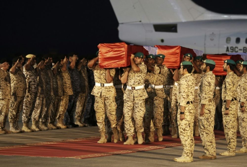 Members of the Bahraini armed forces carry the coffins of comrades who were killed the previous day during fighting against Huthi rebels in Yemen, on September 5, 2015, during an official repatriation ceremony at Isa Air Base in Sakhir, Bahrain