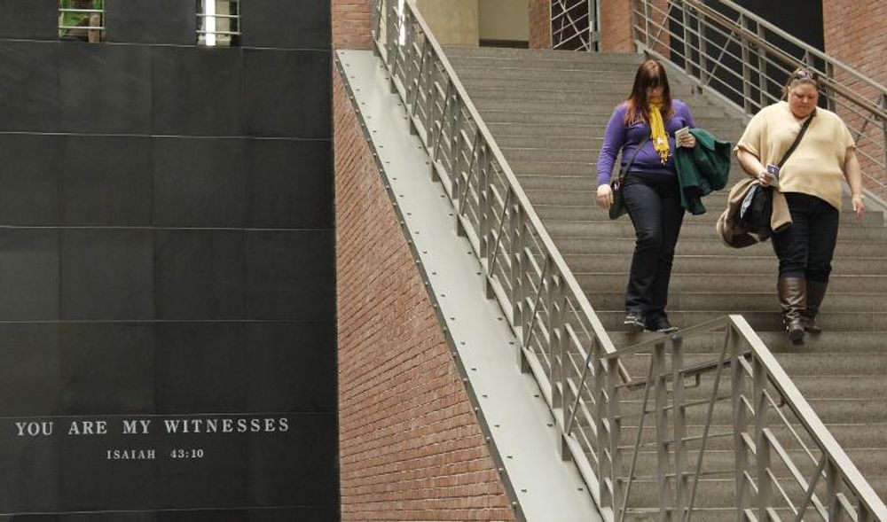 Visitors walk down a staircase at the US Holocaust Memorial Museum in Washington DC, United States, on February 25, 2015.