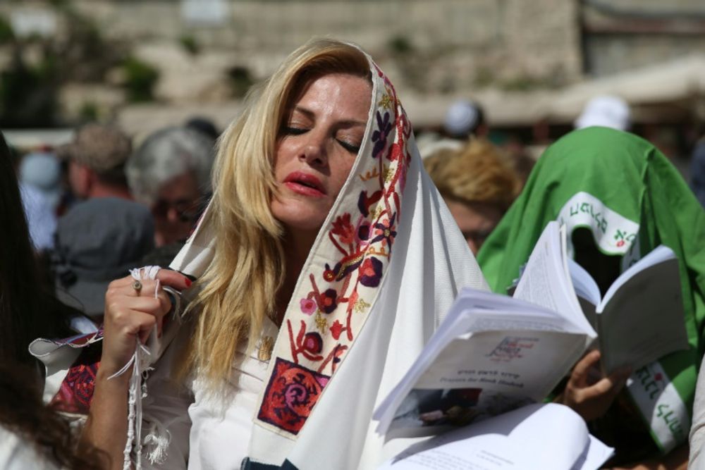 An Israeli member of the liberal Jewish religious group Women of the Wall wears a "Tallit", a traditional prayer shawls for men, on April 24, 2016