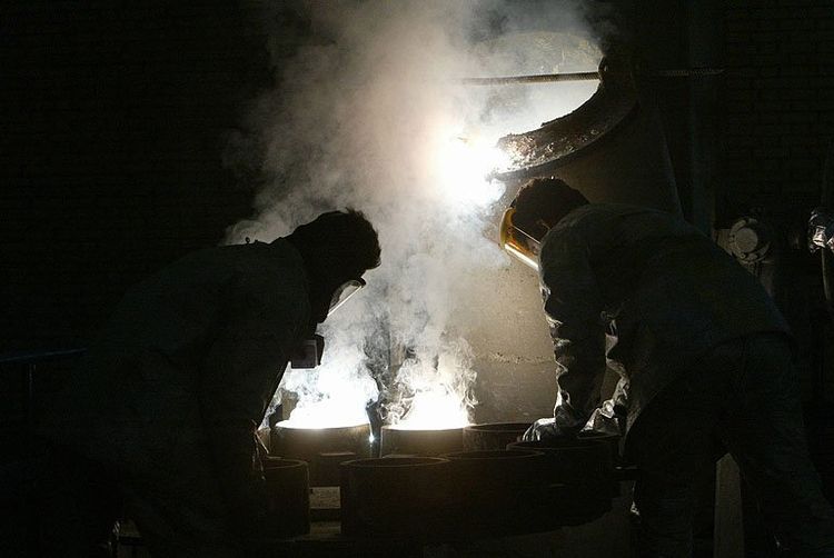 Two technicians help produce zirconium at the Isfahan nuclear facility in central Iran, on March 30, 2005