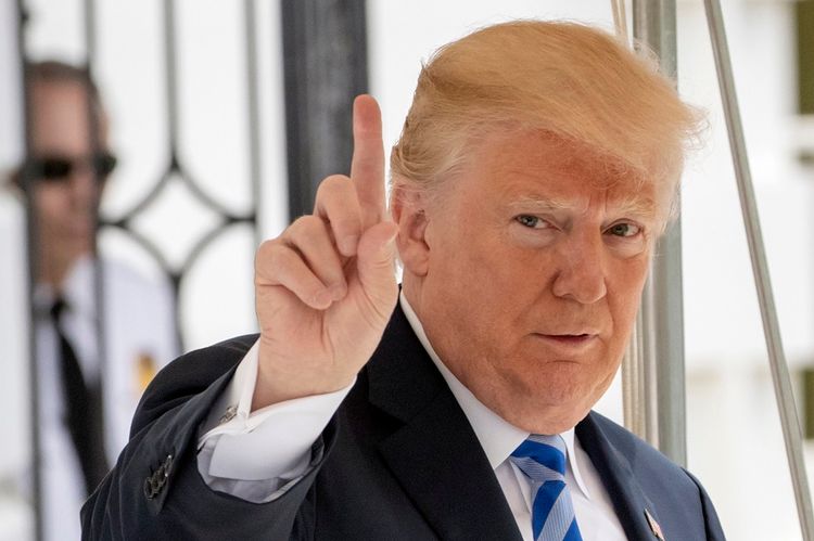 FILE: In this May 4, 2018 photo, President Donald Trump signals to the press that he will come over to talk, as he leaves the White House for Dallas to address the National Rifle Association in Washington. Trump is striking a combative tone against the Ru