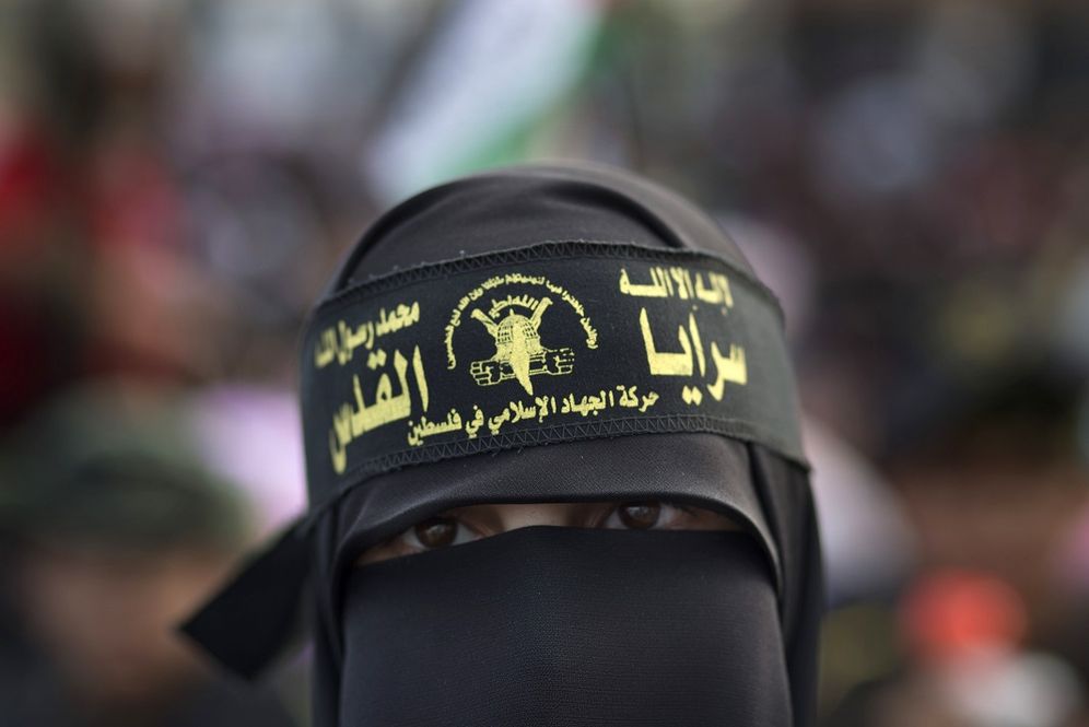 A veiled Palestinian supporter of the Islamic Jihad attends a rally to mark the 25th anniversary of the movement in Gaza City, Thursday, Oct. 4, 2012. The Arabic writing on the woman's headband reads, "no God but Allah, Muhammad is the Prophet. The Islami