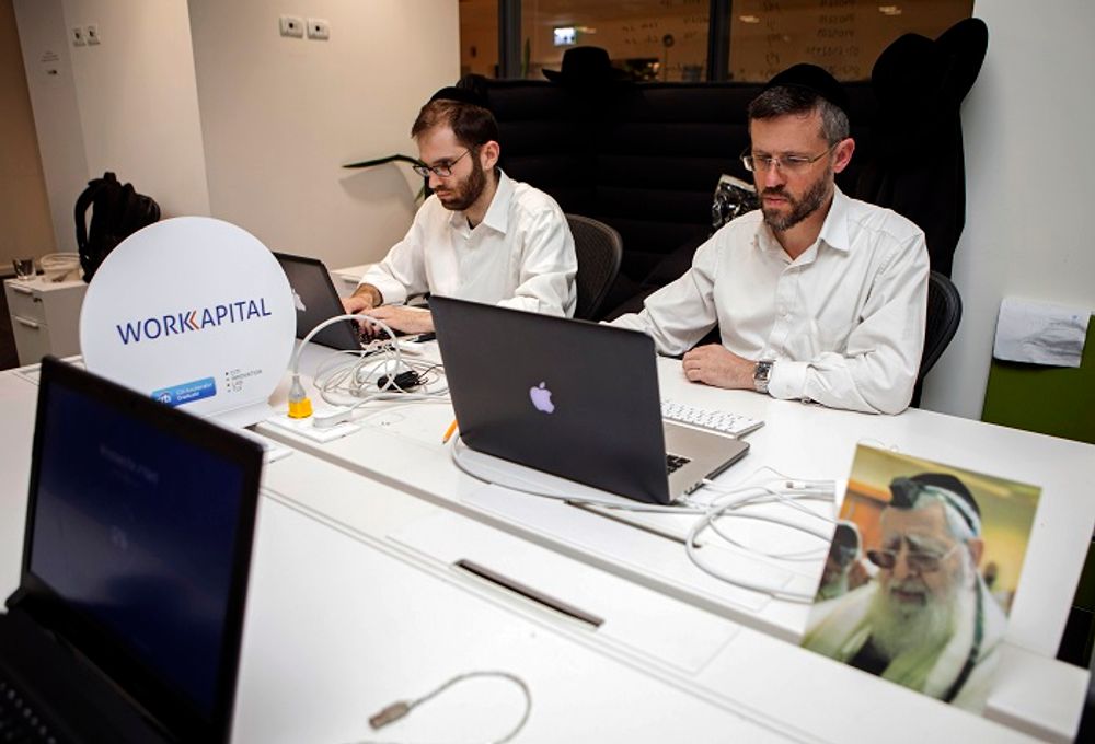 Ultra-Orthodox Jewish men work at a high tech start-up office in Tel Aviv, Israel.