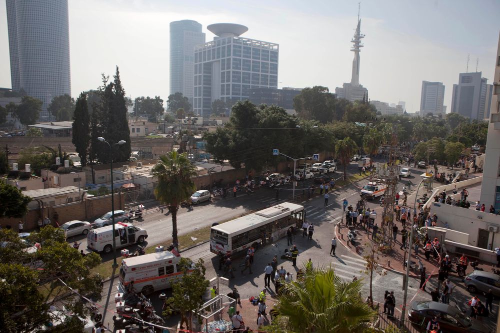 Israel's military headquarters in Tel Aviv are pictured in the background of this Wednesday, Nov. 21, 2012 photo of a bus bombing in the city.