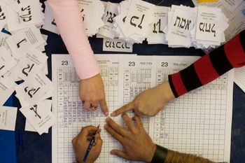 FILE- Israeli election workers count remaining ballots from soldiers and absentees at the Knesset in Jerusalem, Thursday, Feb. 12, 2009.