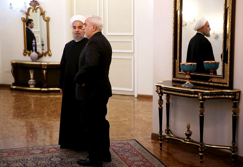FILE - In this Jan. 19, 2016 file photo, Iranian President Hassan Rouhani, left, and Foreign Minister Mohammad Javad Zarif talk while waiting to welcome then-Pakistani Prime Minister Nawaz Sharif for a meeting in Tehran, Iran.