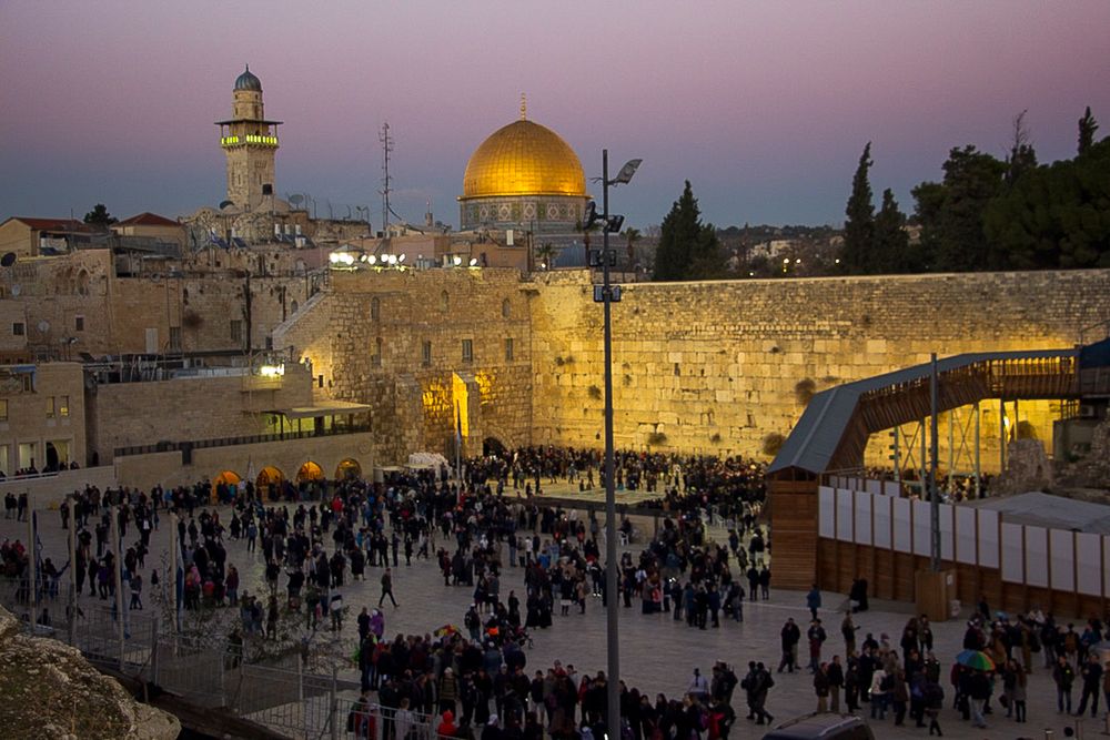 People arrive at the Western Wall for the menorah lighting ceremony on December26, 2016