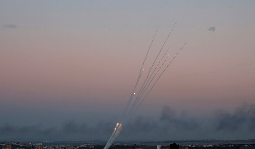 Palestinian rockets cross the sky after militants attack an Israeli bus with a mortar, in Gaza City, Monday, Nov. 12, 2018.