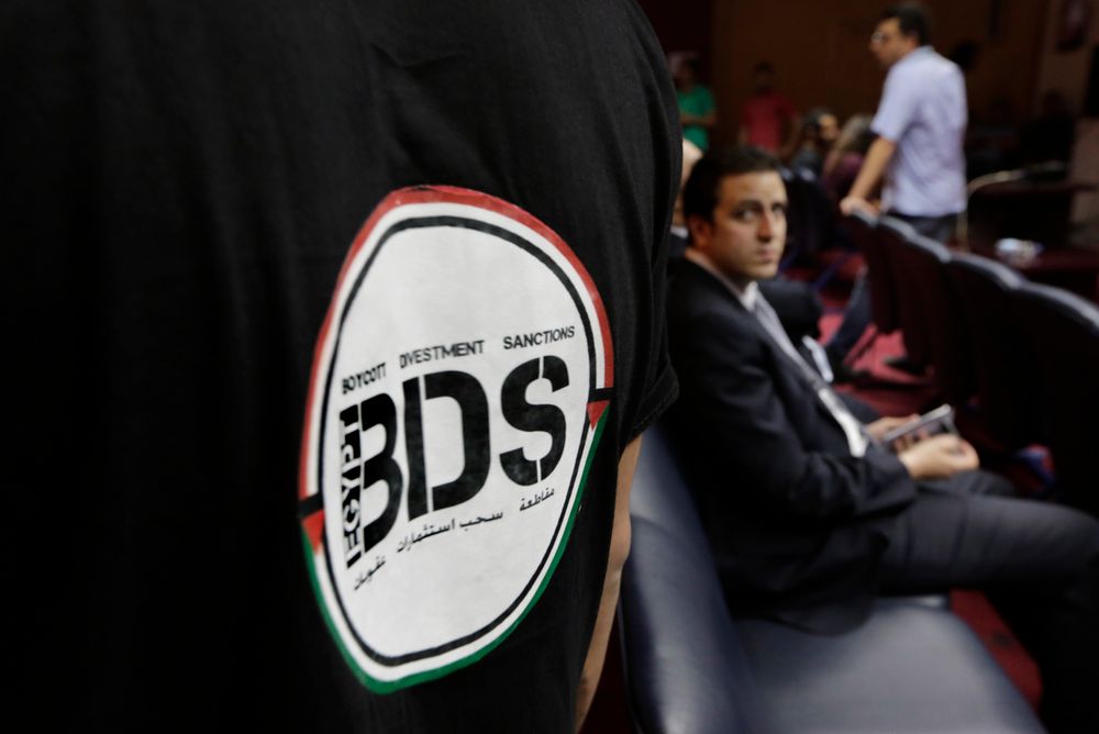 FILE - In this Monday, April 20, 2015 file photo, an Egyptian wears a T-shirt with a logo of BDS (boycott, divestment and sanctions), a campaign started by Palestinian activists to boycott Israel and Israeli-made goods, during the launch of its campaign a
