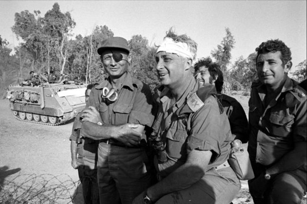 photo credit: IDF Archives Israeli army Southern Command General Ariel Sharon (C) with Defense Minister Moshe Dayan during the Yom Kippur War in October 1973 on the western bank of the Suez Canal in Egypt.