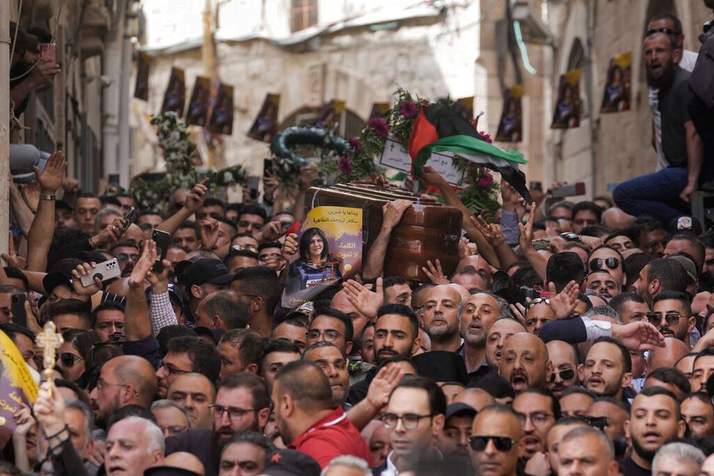 Mourners carry the casket of slain Al Jazeera journalist Shireen Abu Aqleh during her funeral in Jerusalem, on May 13, 2022.