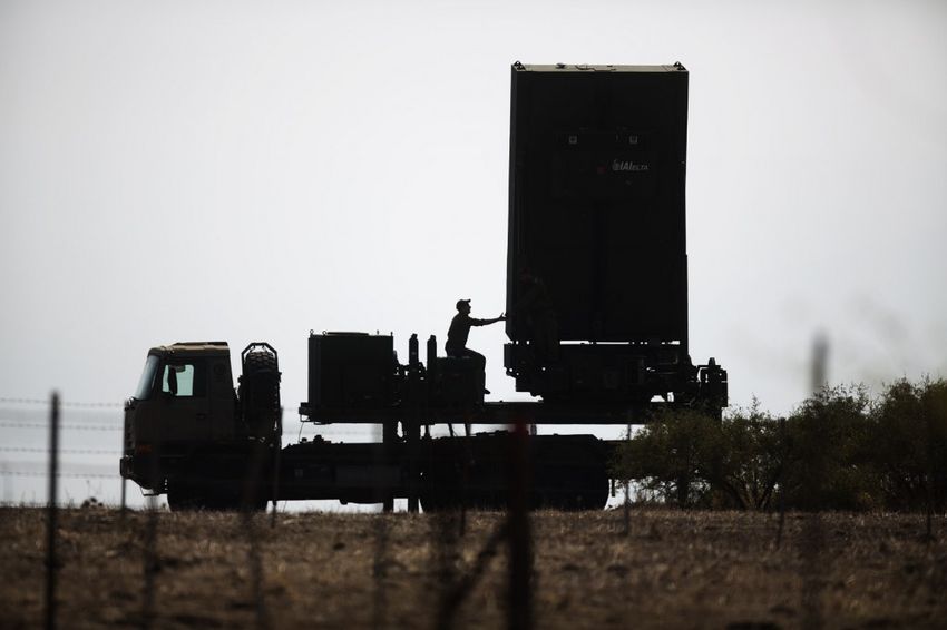 An Israeli soldier sits next to an anti-missile radar positioned in the North of Israel on August 29, 2013.