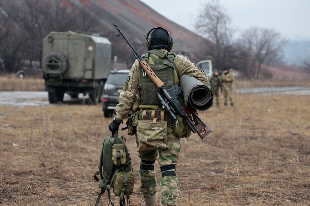 A Russian army soldier carries his equipment in Donetsk region, eastern Ukraine.