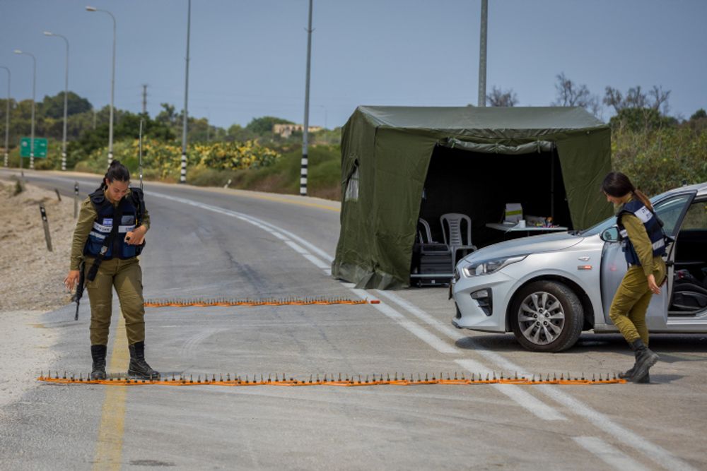 Israeli soldiers block a road in southern Israel near its border with the Gaza Strip, on August 4, 2022.