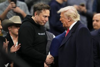 Elon Musk, left, shakes hands with US President Donald Trump at the finals for the NCAA wrestling championship
