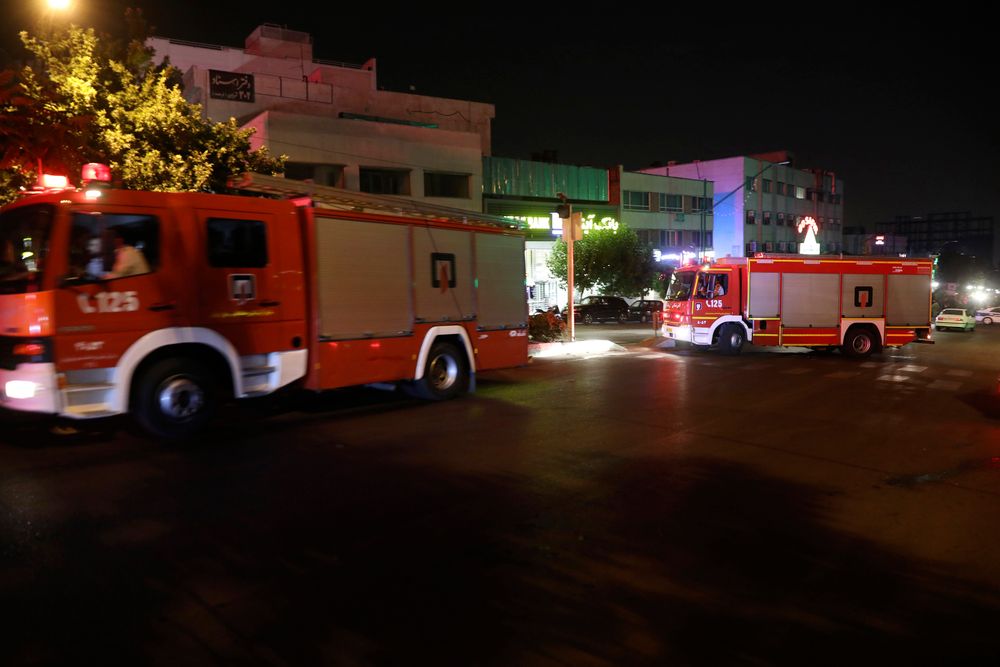 Firefighters arrive for additional support after the fire from the explosion of Sina Athar Clinic is extinguished by their colleagues, in Tehran, Iran, July 1, 2020.