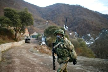 A Russian peacekeeper guards an entry of the Dadivank, an Armenian Apostolic Church monastery near Kalbajar, Azerbaijan, on December 2, 2020.