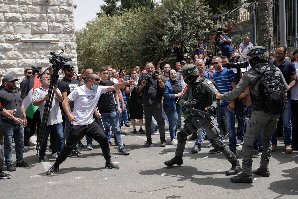 Israeli police confront mourners at the funeral of slain Al Jazeera journalist Shireen Abu Aqleh in Jerusalem, on May 13, 2022.