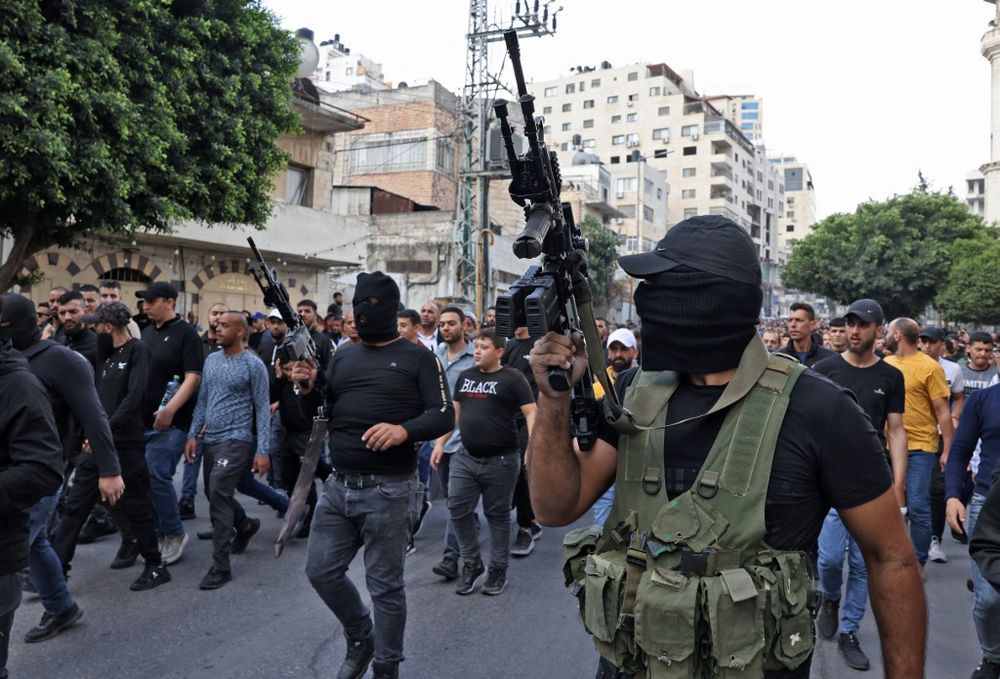 Palestinian militants attend the funeral of those killed in an overnight Israeli raid, in the West Bank city of Nablus.