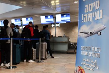 People check in at a counter in Ben Gurion international airport in Tel Aviv, Israel, for the first commercial flight from Israel to Doha for the World Cup 2022 tournament.