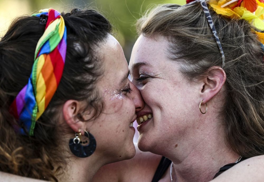 Participants kiss during the annual Pride parade in Jerusalem, on June 2, 2022.