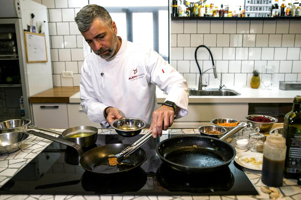 Chef Amir Ilan prepares a lab-grown steak during a presentation by the Israeli company Aleph Farms, in Jaffa, Israel.