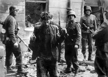 A Jew is arrested by German soldiers on April 20, 1943, after the uprising of the Warsaw Ghetto in Poland.