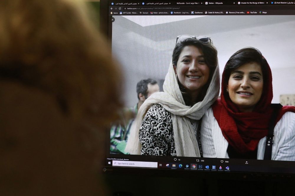 A woman looks at a picture of Iranian reporters Niloufar Hamedi and Elahe Mohammadi posted on twitter. Concern is growing over the fate of the two Iranian reporters.