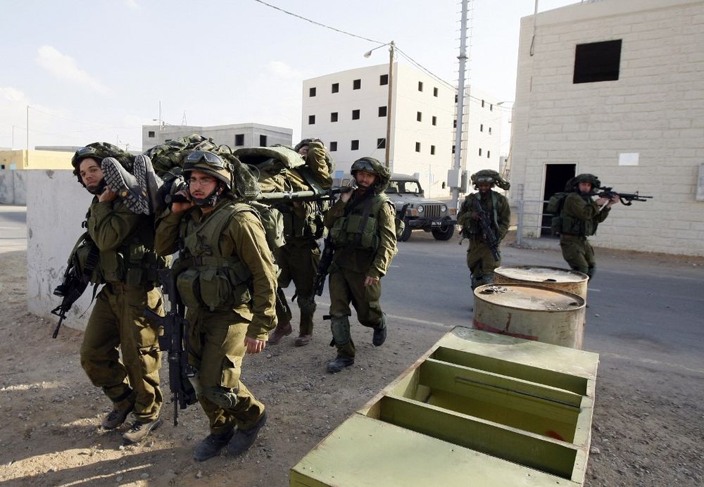 Israeli army reservists simulate the evacuation of a wounded soldier during a training at the Urban Warfare Training Centre in Tse'elim camp in southern Israel.