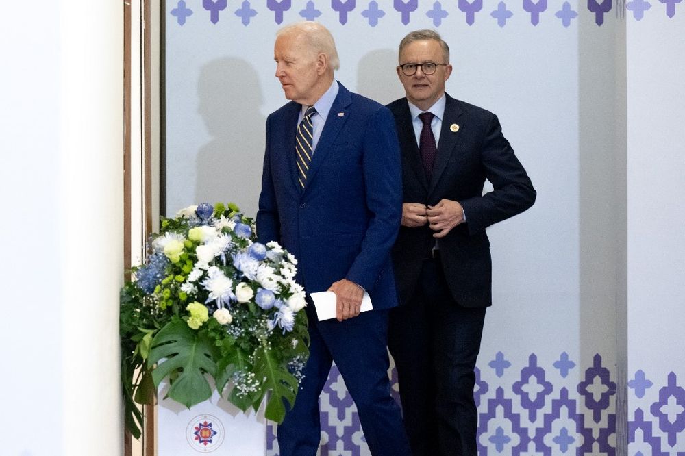 U.S. President Joe Biden (L) walks with Australia's Prime Minister Anthony Albanese (R).