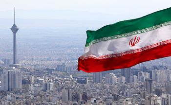 FILE - In this March 31, 2020, file photo, Iran's national flag waves as Milad telecommunications tower and buildings are seen in Tehran, Iran. A British-Australian academic serving a 10-year sentence for espionage in Iran has been moved to a notorious prison where concerns for her well-being have escalated, the Australian government confirmed Wednesday. 
