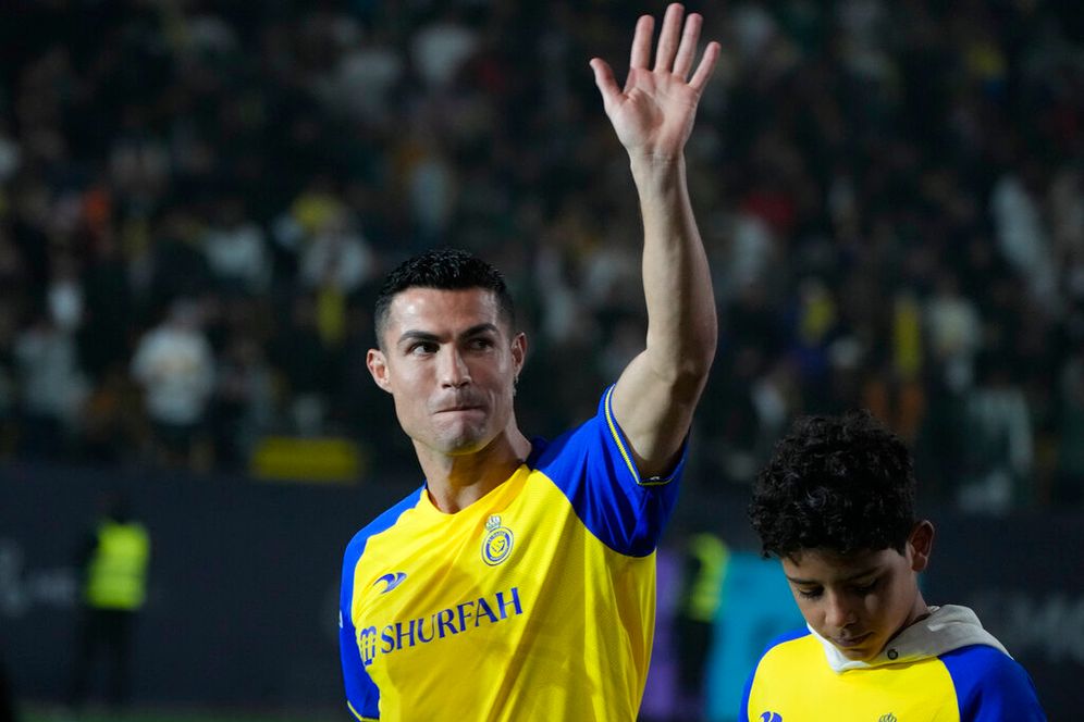 AP Photo/Amr Nabil Cristiano Ronaldo reacts during his official unveiling as a new member of Al Nassr soccer club in in Riyadh, Saudi Arabia, Tuesday, Jan. 3, 2023.Ronaldo, who has won five Ballon d'Ors awards for the best soccer player in the world and five Champions League titles, will play outside of Europe for the first time in his storied career.